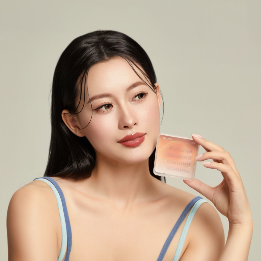 Woman holding a CoreLash lash cluster product against a neutral background